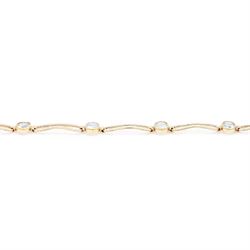 Gold blue topaz bracelet, bezel set with five oval cut topaz's, each spaced by fancy rectangular links, stamped 9ct
