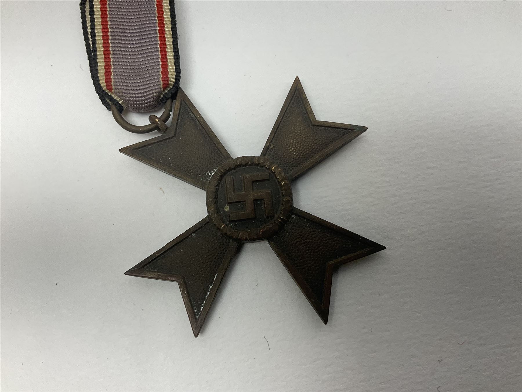 Five WW2 German medals/badges -German Defences West Wall Medal, War merit Cross, Red Cross Decoration, RAD tinnie brooch and Adolf Hitler 1934 medallion (5)
