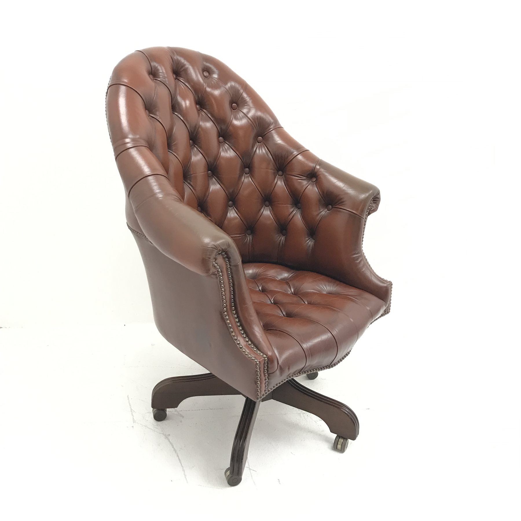 Library style swivel reclining desk chair, upholstered in deep buttoned