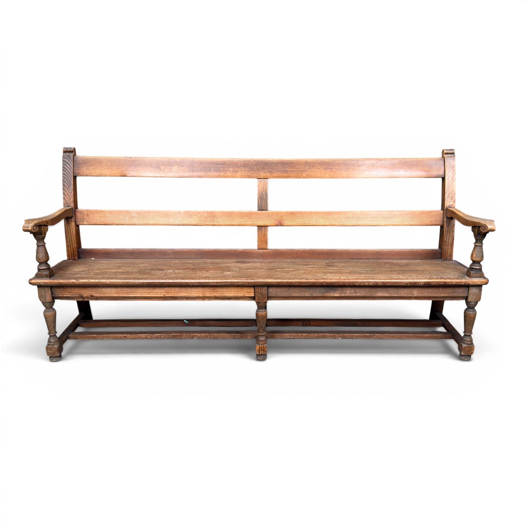 Early 20th century pine and oak bench seat, stained pine rail back frame with shaped oak arms