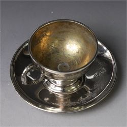 German silver cup and saucer, both with engraved foliate decoration, stamped 800, the saucer with crescent and crown mark