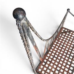 Victorian design wrought iron garden bench, with asymmetrical rope-twist frame, arched back and sides over out-swept arm terminals with ball finials, flanking a lattice seat, in antique black-painted weathered finish