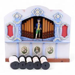 John Smith-20th century hand cranked portable street organ “music and mirth” in a wooden case with carrying handles, with speaking pipes and mannequin to the front. All pipes present, however the mechanism is in need of restoration. With five paper music rolls.