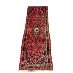 Persian red ground runner, central medallion, floral field, repeating boarder 