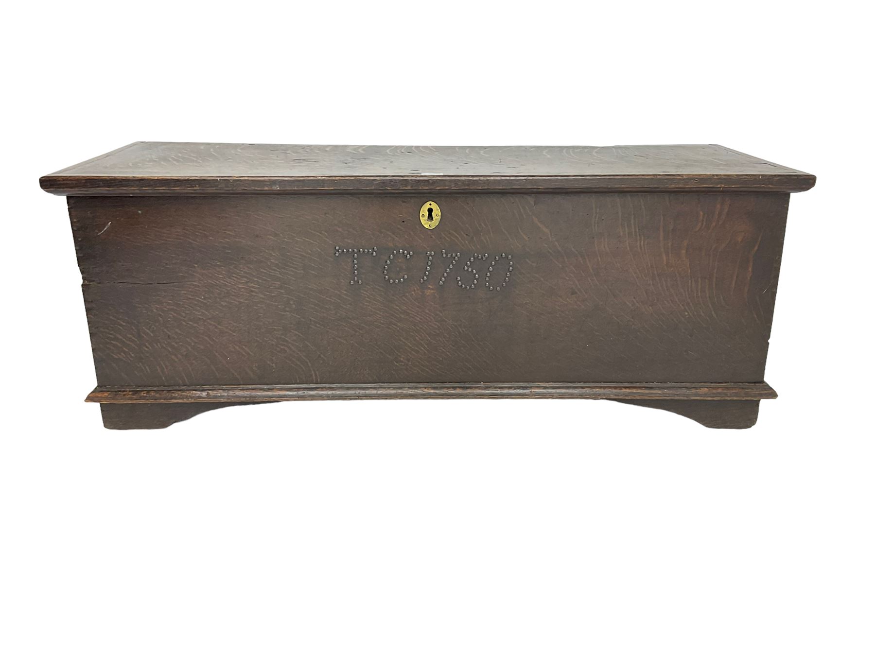 18th century oak sword chest or coffer, hinged lid with moulded edge and iron fittings concealing candle box and main compartment, the front with studwork spelling 'TC 1750', raised on bracket feet