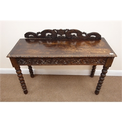  Victorian heavily carved oak side table, raised pierced back, two drawers, turned supports, 'James Phillips Sons Ltd', W120cm, H90cm, D45cm   