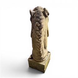 Large weathered cast stone horse head figure, raised on square plinth