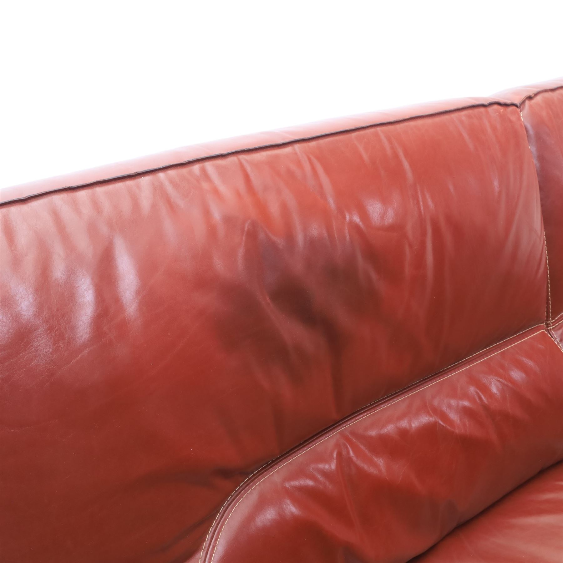 Fabrizio Mantellassi - 20th century Italian red leather suite, one three seat and two large armchairs, upholstered in deep red hide with stitched seam detailing, with magazine pockets to each side, the rectangular back cushions above broad padded arms and seat cushions, raised on low block bases

Sofa: H c98m, W 203cm, D 92cm
Armchair: H 98cm, W 113cm, D 92cm