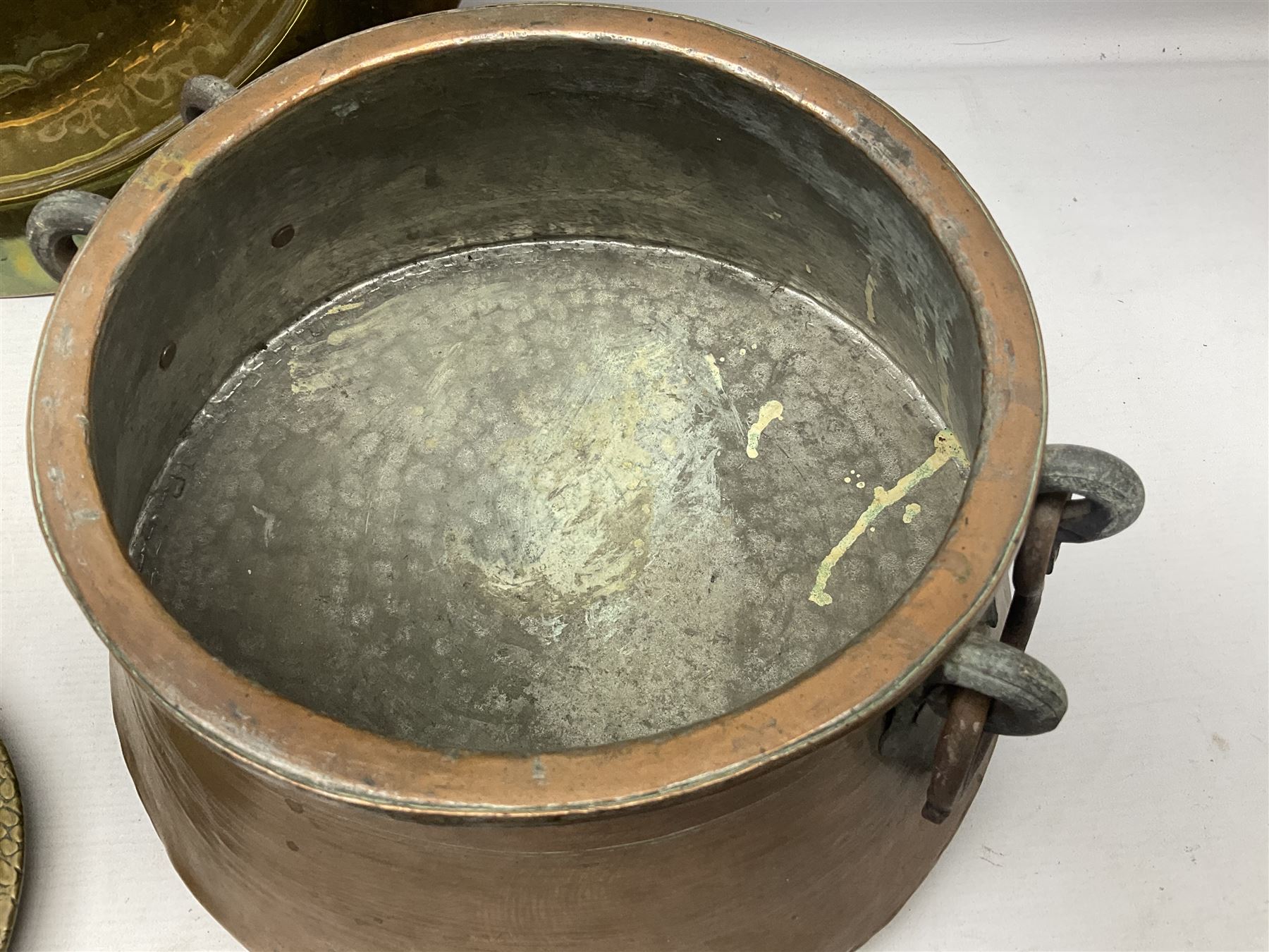Copper pot with twin iron handles, large heavy planished brass charger and brass crocodile tray, charger D59cm