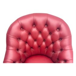 Kingsgate - contemporary 'Devon' bucket armchair, upholstered in red leather with buttoned backrest, rolled arms and brass stud detailing, raised on four dark wood supports with vertical carving