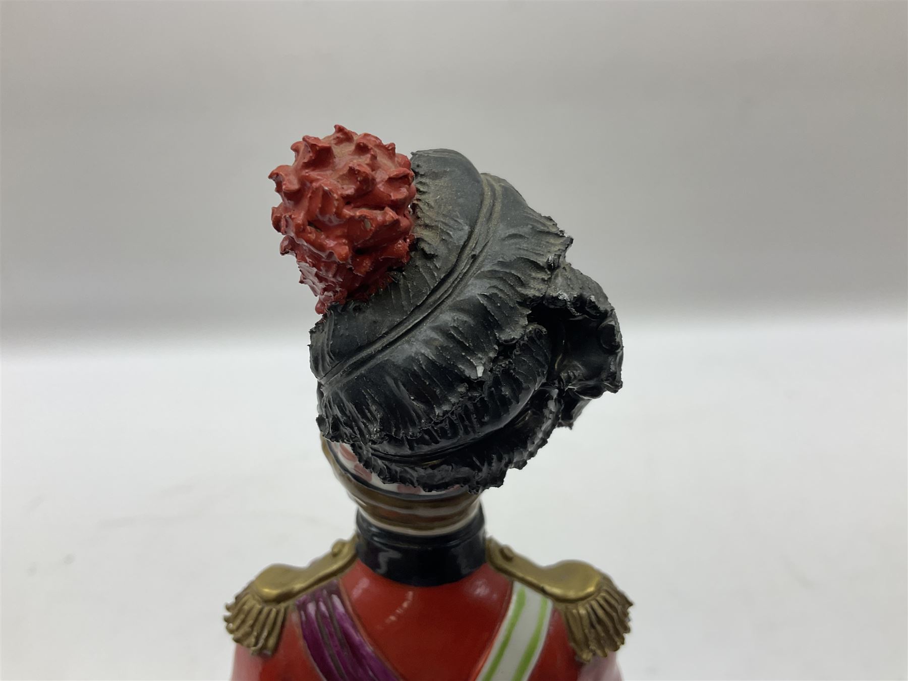 Sitzendorf figure, The Black Watch officer, c1815 standing to attention in full dress with sword, blue factory marks beneath, H28cm