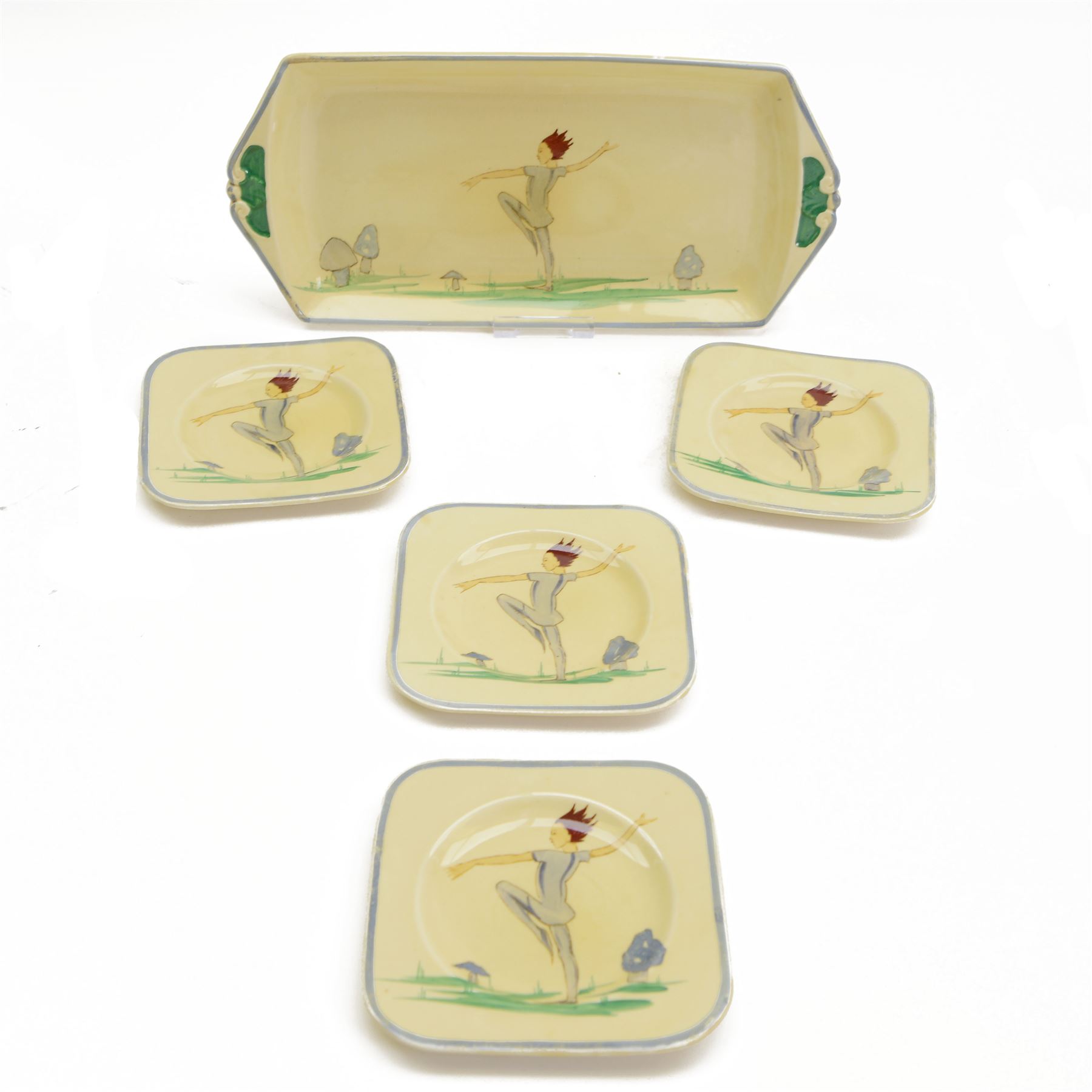Susie Cooper Puck pattern twin-handled tray and four serving plates, decorated with a dancing figure and toadstools, tray L32cm plates D13cm
