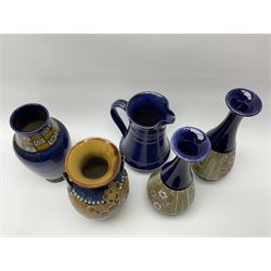 A Collection of Royal Doulton, to include a pair of Slaters Patent vases of baluster form with foliate decoration upon a blue ground, H28, a twin handled Doulton Burslem vase, H24cm, etc., each with impressed marks beneath. 