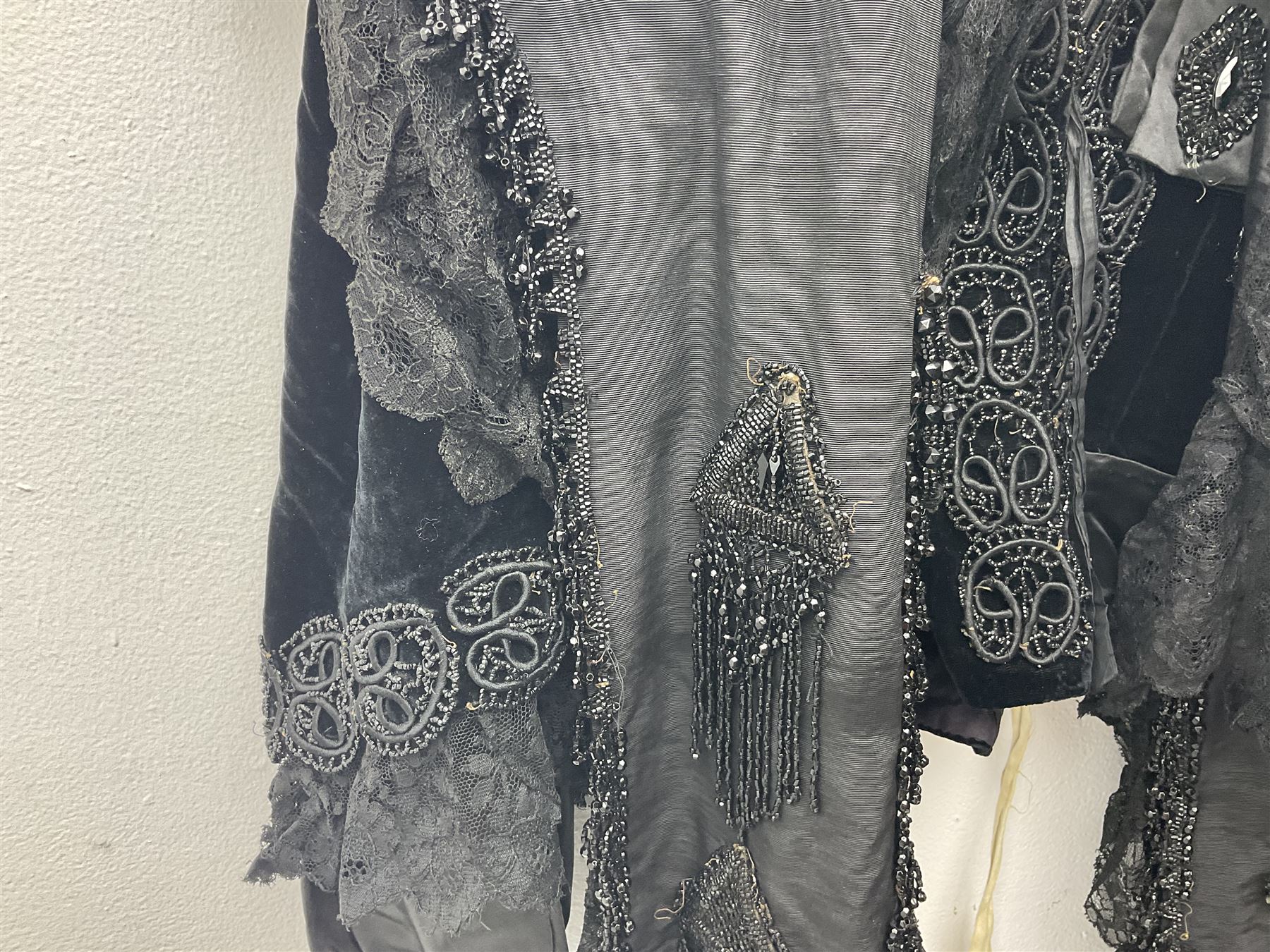 Victorian three piece mourning dress, with lace trim and jet beading, including velvet coat with satin collar panels and cuffs, the nipped waist with boning and slight flared peplum, heavily embellished beaded high neck collar, and ladies embroidered silk lined purse with gilt handle, mount and clasp