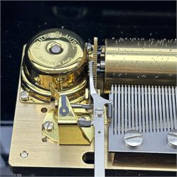 Reuge Sainte-Croix- 21st century Swiss musical box with a highly polished lacquered finish, inlaid and ebonised case with a glazed internal viewing lid, polished steel 144 teeth two-part comb playing three arias from The Phantom of the Opera by Lloyd Webber, with tune indicator and tune sheet.