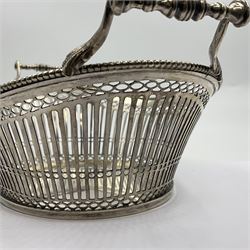 Early 20th century Dutch silver basket, of oval form with pierced sides, beaded rim, and twin handles, marked with Lion Passant for 2nd standard purity and date letter for 1910, other marks worn and indistinct, including handles H8.5cm L25.5cm