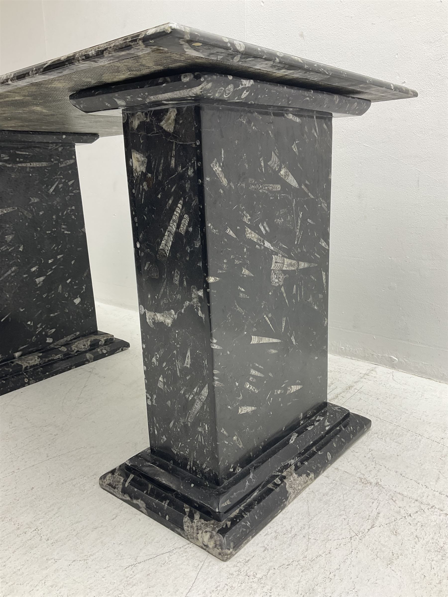 Marble hall table with orthoceras and goniatite inclusions, the rectangular top upon two rectangular stepped plinths, H75cm, L135cm, D78cm 