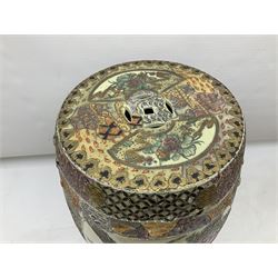 Oriental pierced ceramic garden seat, heavily decorated with birds upon blossoming branches and butterflies within panelled geometric stylised borders, H45cm