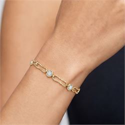 Gold blue topaz bracelet, bezel set with five oval cut topaz's, each spaced by fancy rectangular links, stamped 9ct