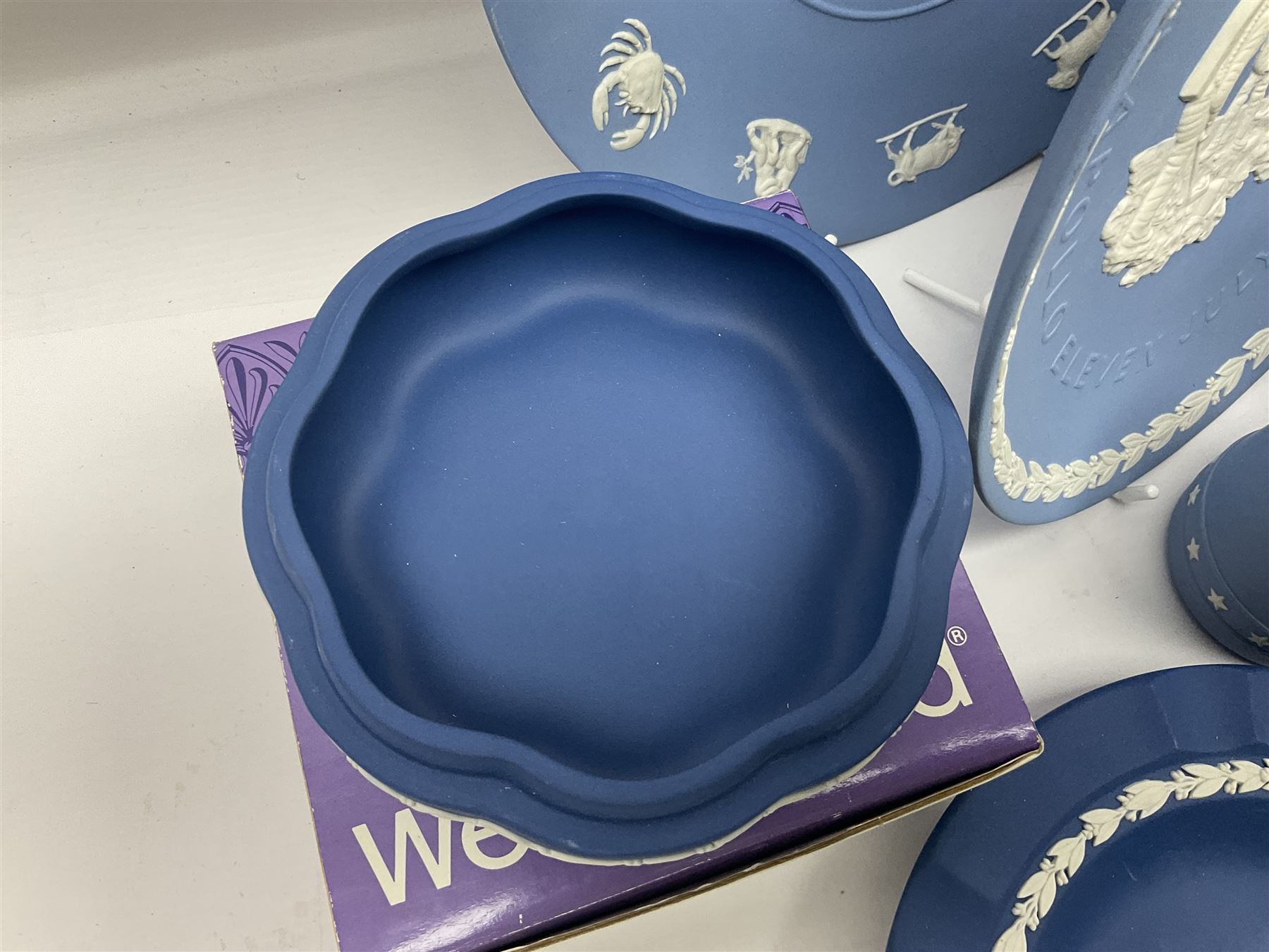 Collection of Wedgwood Jasperware, to include black Eisenhower Bust, two black basalt paperweights, one depicting an eagle and one depicting Julius Caesar, a blue Zodiac plate, Man on the Moon commemorative plate, American Independence Bicentennial plate and Royal commemorative ware, etc, all with impressed marks beneath, some with boxes