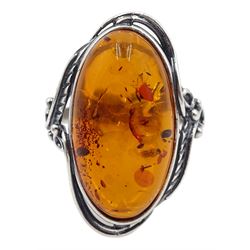 Silver oval Baltic amber ring with leaf design gallery, stamped 925 