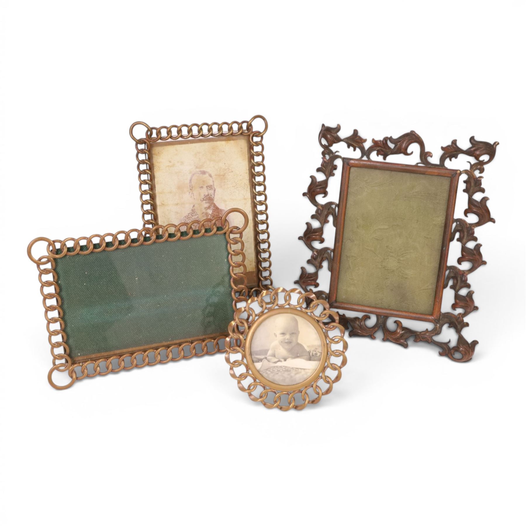 19th Century gilt metal photograph frame of easel form with Rococo scroll decoration, together with three brass link frames, largest H22cm 