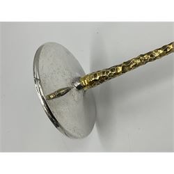 Pair of modern silver candlesticks by Stuart Devlin, the tapering parcel gilt stems with signature textured detailing, each supporting a fluted candle holder and upon a spreading circular foot, hallmarked Stuart Devlin, London 1973, H25cm