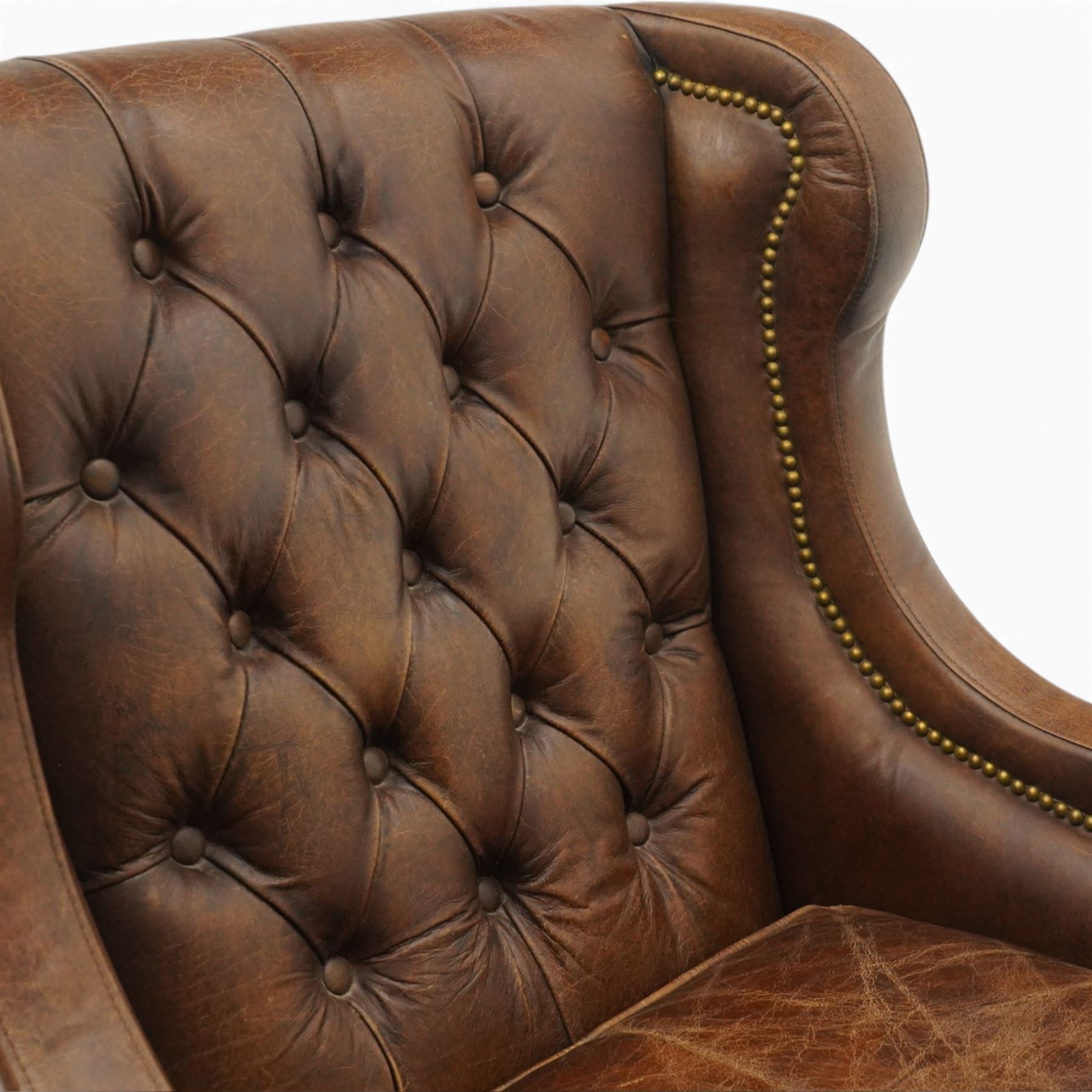 Timothy Oulton - pair of wingback armchairs upholstered in back-buttoned chocolate brown leather with loose seat cushion, raised on square tapering feet
