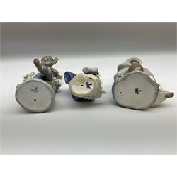 Pair of Lladro figures designed by Jose Roig, Bongo Beat no. 5157 and A Step in Time no. 5158 and a Lladro figure of a girl with a basket of flowers.
