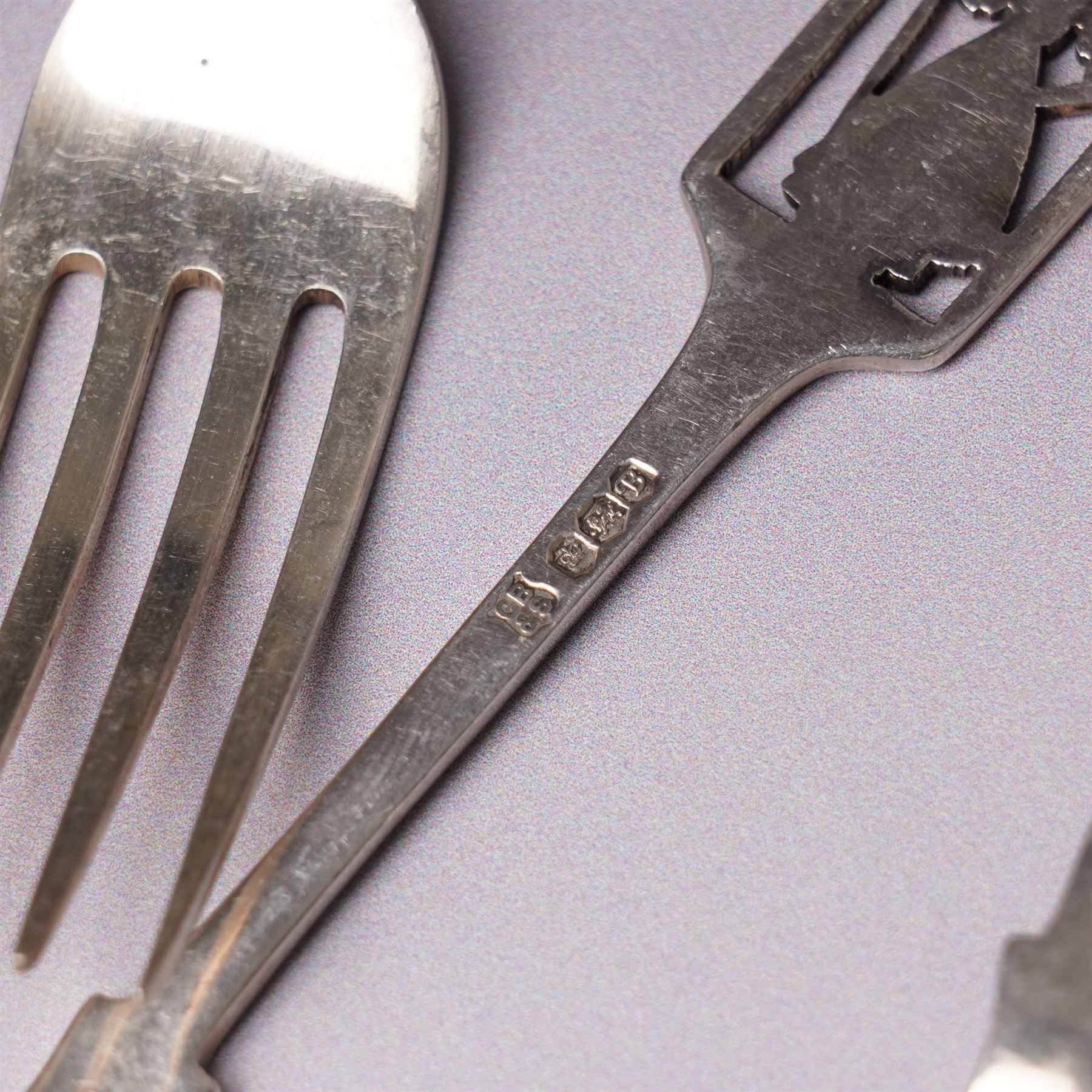 Small silver photograph frame,  four decorative silver forks, two silver and enamel spoons, other silver spoons and silver cased fob watch 