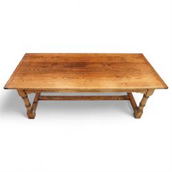 Late 20th century oak refectory table in 17th century style, with plank top and end leaf, raised on ring turned baluster legs with square feet, joined by conforming stretchers (260 cm extended)
