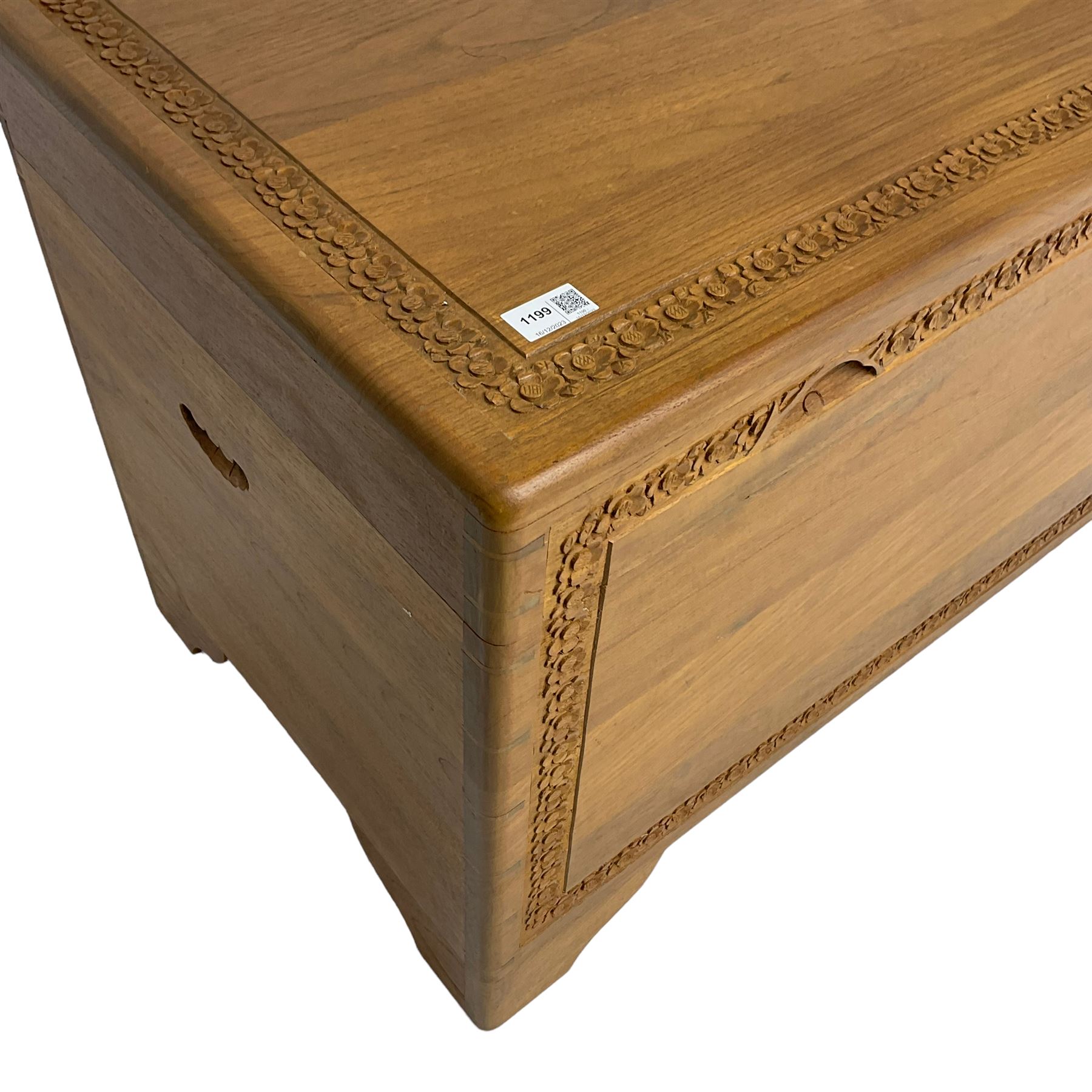 Mid-to-late 20th century Singapore camphor wood blanket chest, the hinged lid and front decorated with flower head carved bands