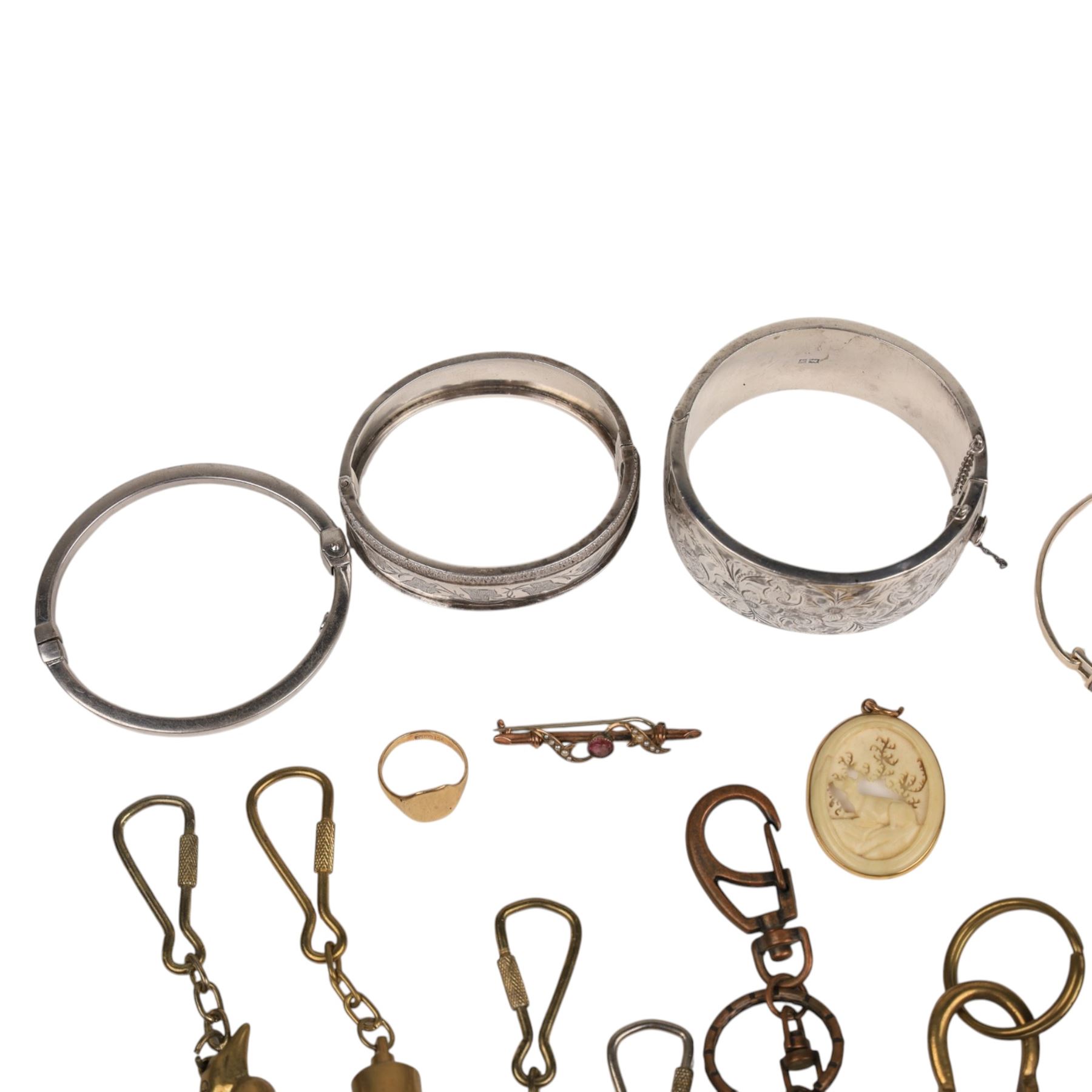 9ct gold jewellery, including bone deer pendant in gold mount, signet ring and stone set brooch, all stamped or hallmarked, three silver bangles, base metal bangle, brass diving related keychains and a Tag Heuer quartz wristwatch