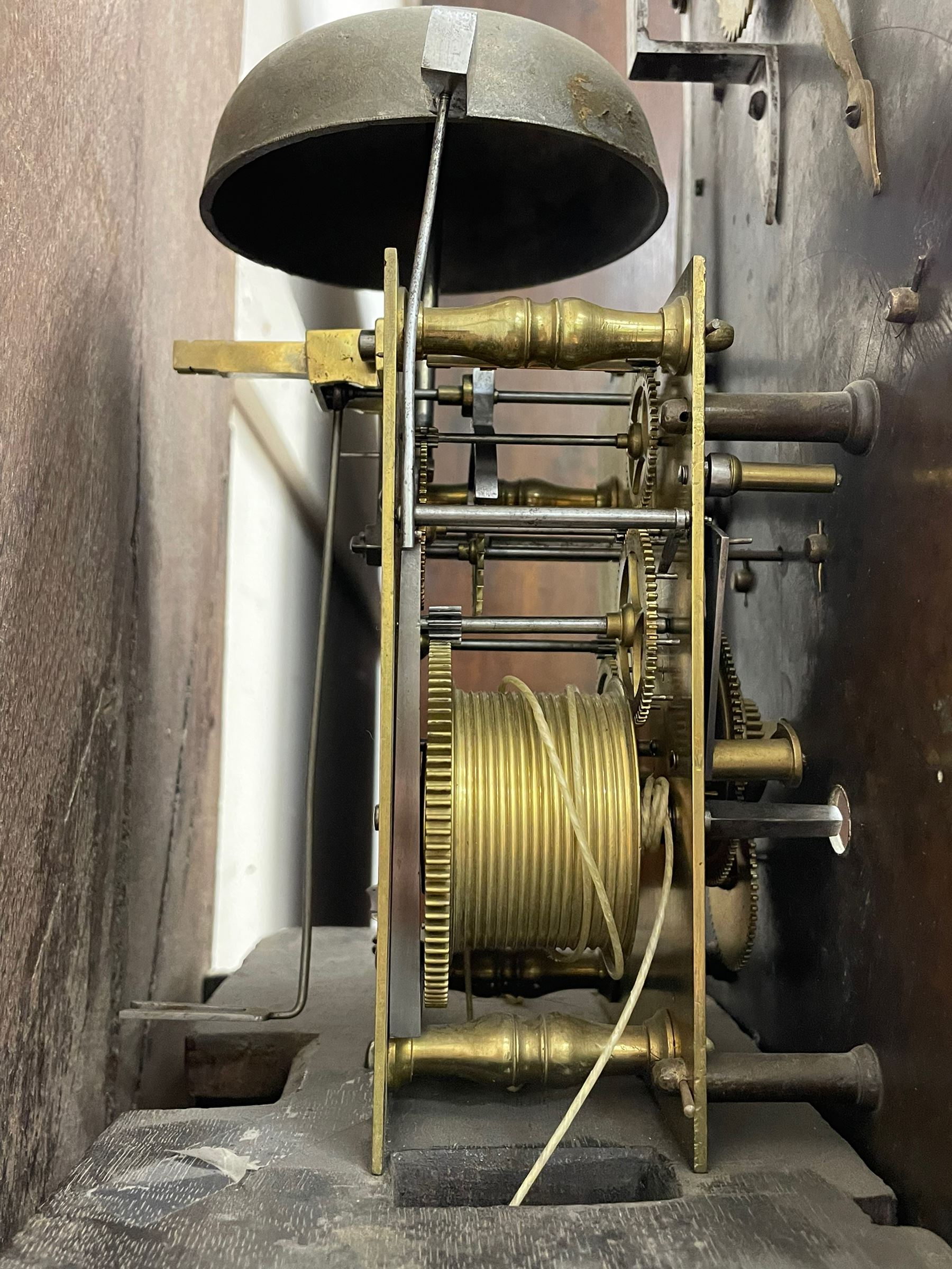 Henry Hindley of York – mid-18th century oak cased 8-day longcase clock,
flat topped caddy pediment with gesso finials, rectangular hood door flanked by wooden turned pilasters with capitals, canted trunk with a full-length break arch topped door on a short plinth with applied skirting and bracket feet, brass dial with a silvered chapter ring, Roman numerals and five-minute Arabic’s, minute and inner quarter hour tracks, matted dial centre with subsidiary seconds dial, blued steel hands and female head pattern spandrels, silvered calendar dial to the break arch with dolphin spandrels, four pillar rack striking movement, striking the hours on a bell. With weights and pendulum. 
H250 W48 D27
Henry Hindley originally from Wigan (Lancs) is recorded as working in York from Petergate 1731-41 then Stonegate 1741-1771. A famous and highly innovative maker, often referred to as the “Tompion of the North.” 
