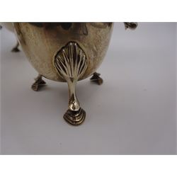 1920s three piece silver tea service, comprising teapot, with ebonised wooden handle and finial, milk jug and open sucrier, all of circular form, with shaped rims, and upon three hoof feet, hallmarked Wakely & Wheeler, London 1922, teapot H19cm