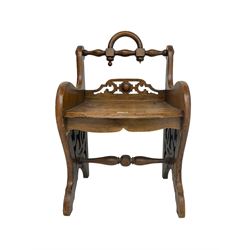 Late 19th century oak low stool, turned top rail with looped handle, shaped end supports with pierced decoration, turned stretcher 