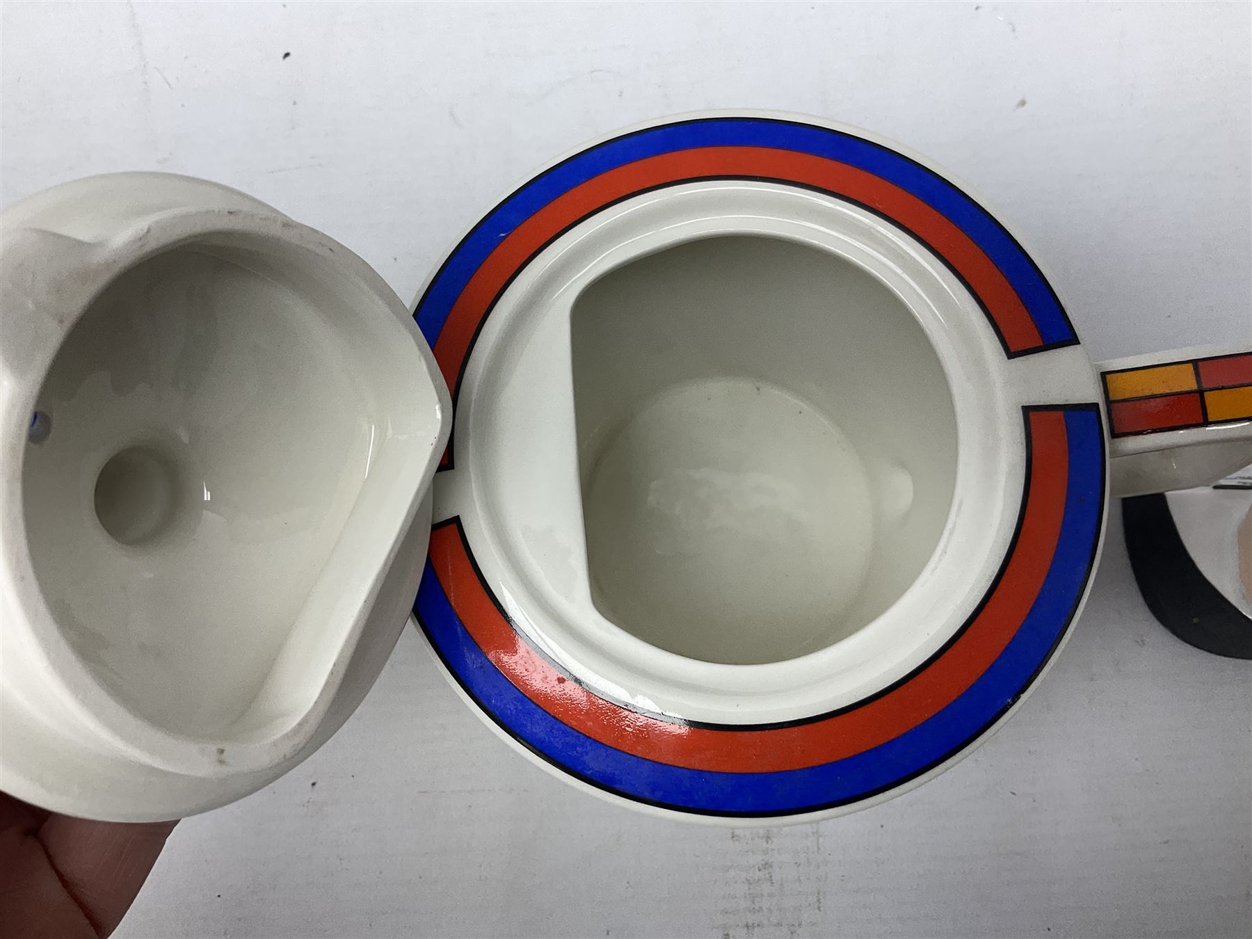 Novelty ashtray modelled as bald headed singer, the base entitled `By the light of the silvery moon...' together with a Sadler teapot of Clarice Cliff Farmhouse pattern style