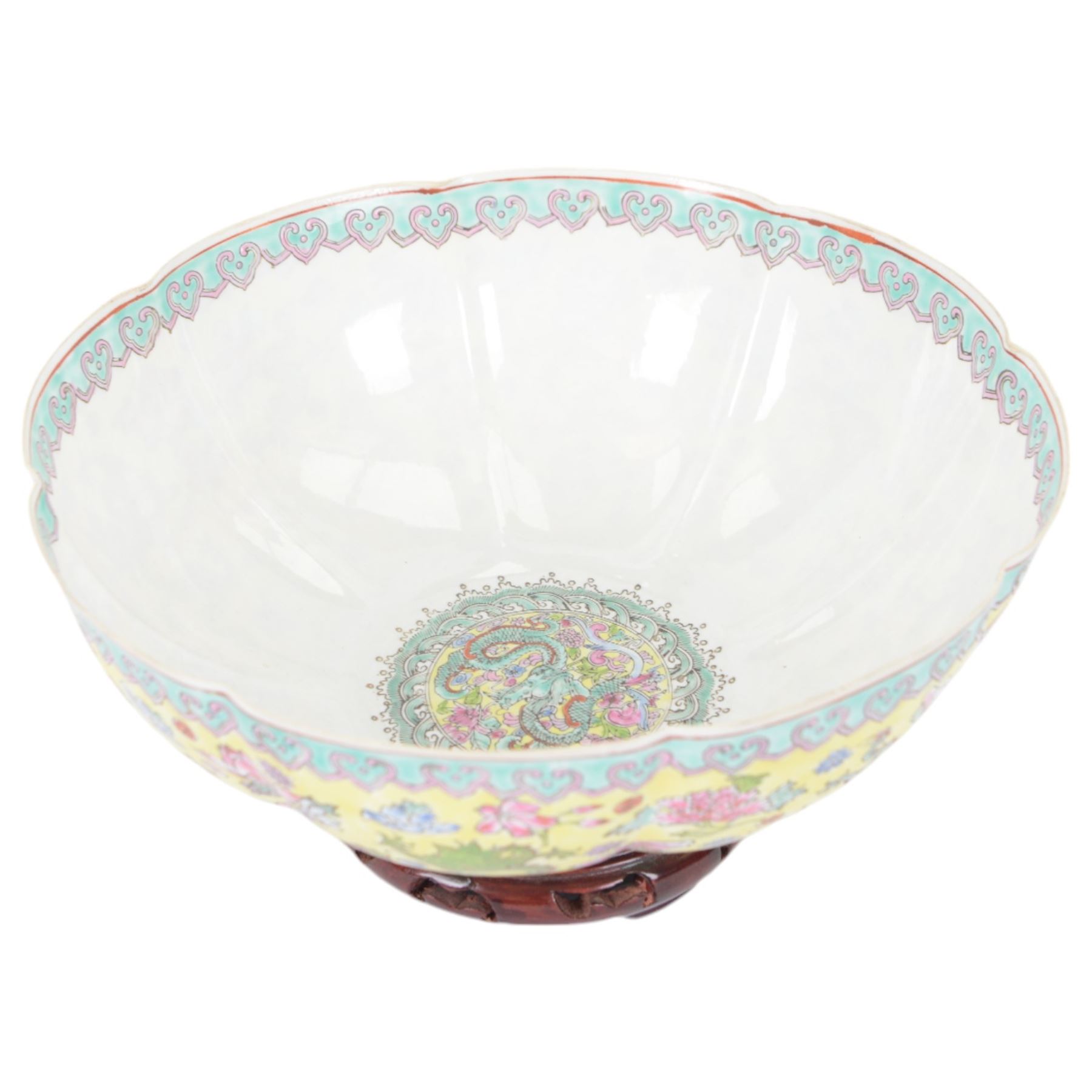 Chinese famille jaune eggshell porcelain bowl, decorated with dragons and foliage, upon hardwood stand, D26cm