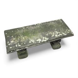 Weathered cast-stone garden bench with squirrel designed supports and rectangular top