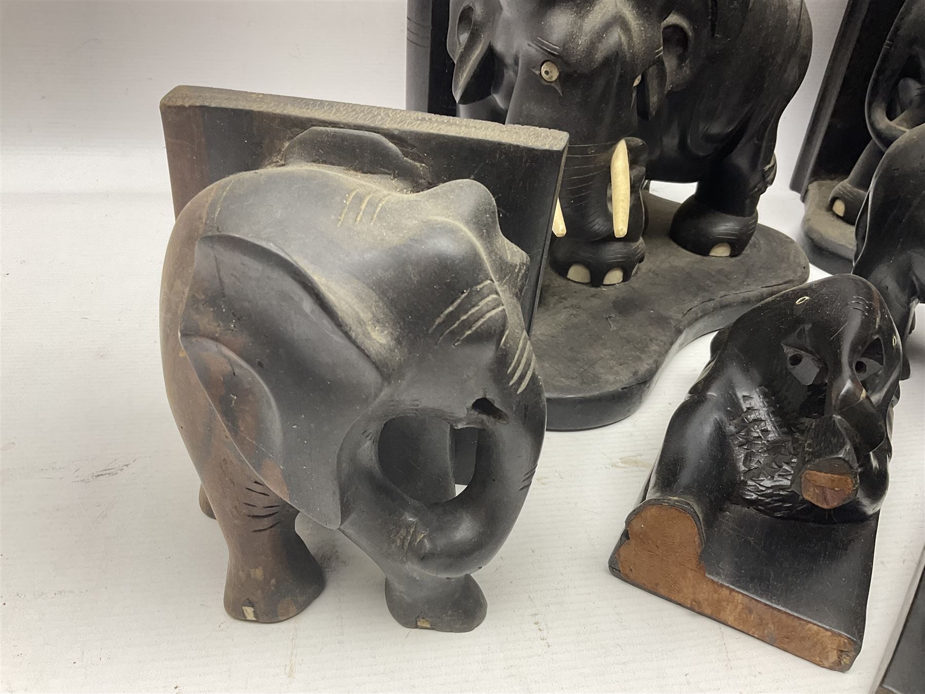 Three pairs of carved wooden elephant bookends, and a similar carved wooden elephant figure, tallest H24cm