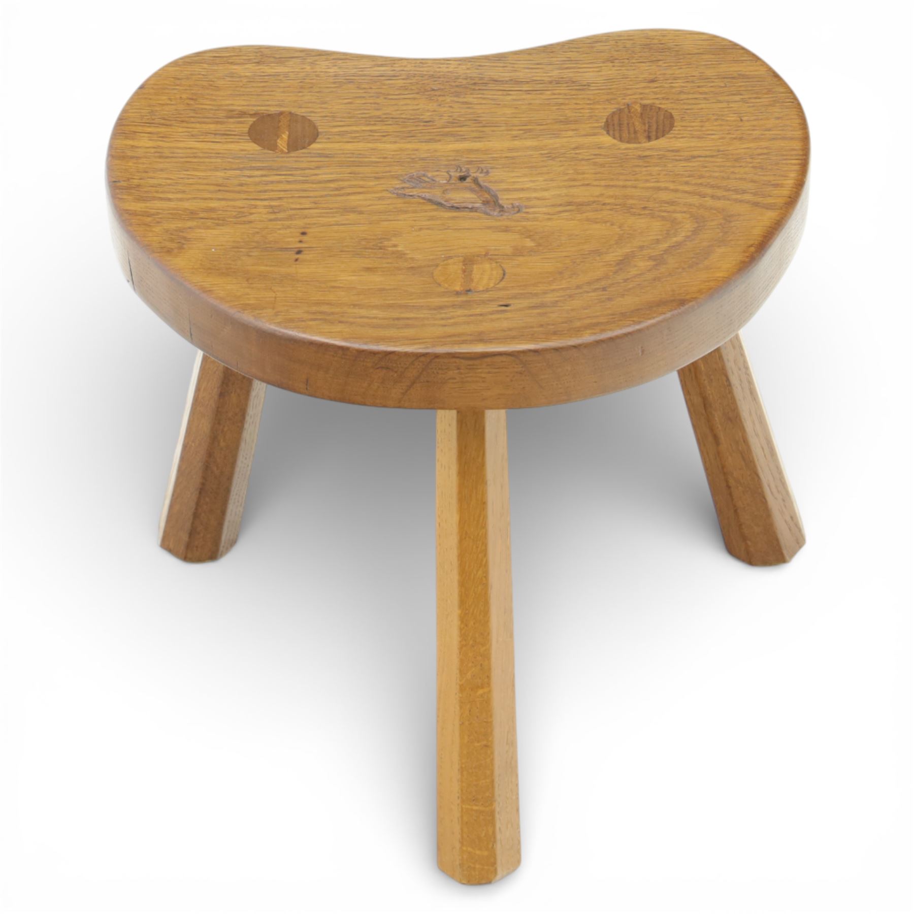 Eagleman - small oak calf stool, raised on three octagonal supports with signature Eagle motif to the seat from the workshop of Albert Jeffray, Sessay