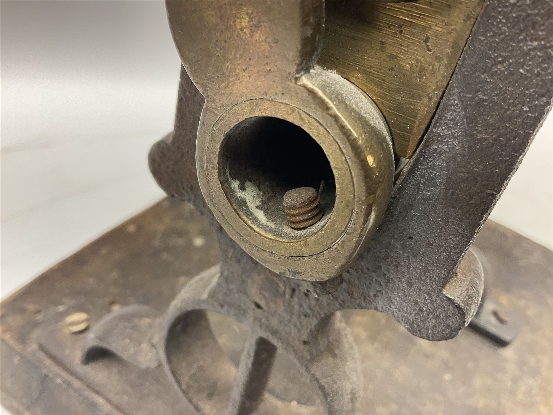 Victorian cuff and collar tabletop mangle, the ribbed brass rollers in a cast iron frame mounted on a wooden base