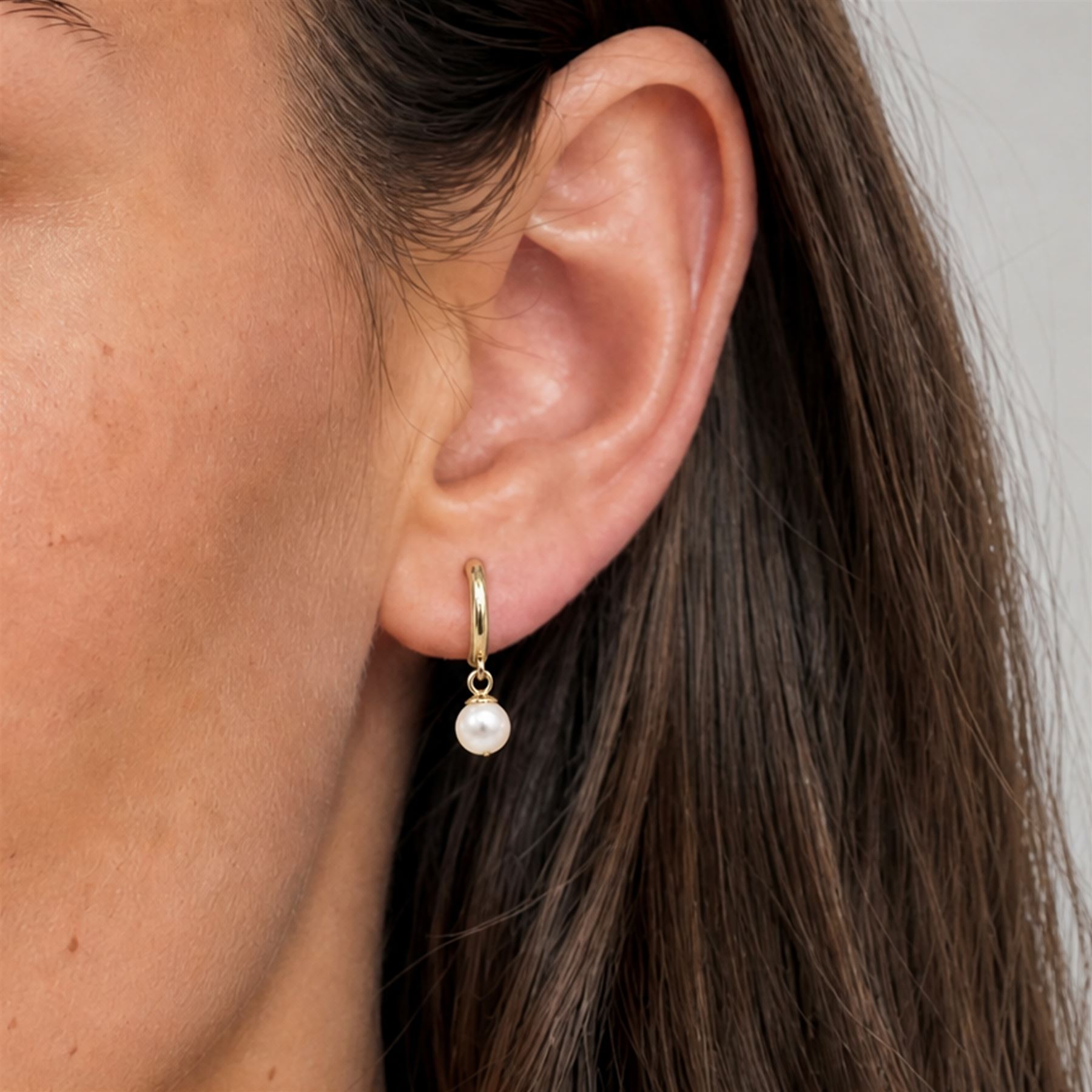 Pair of 9ct gold pearl pendant earrings, each stud set with a single white pearl, stamped 375