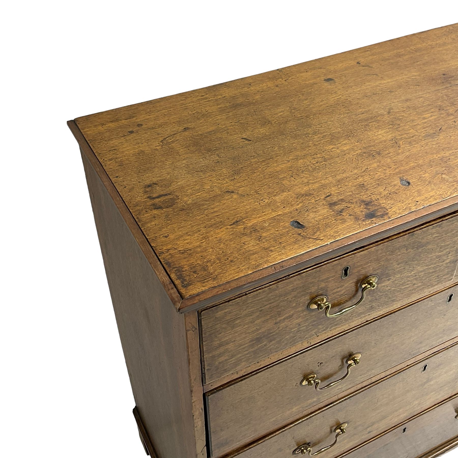 George III oak straight-front chest, fitted with two short over three long graduating drawers, lower moulded edge over shaped bracket feet