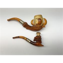 A carved meerschaum pipe depicting a lady in a tricorn hat with a silver hallmarked collar, in original case, along with a carved meerschaum pipe depicting a eagle claw with a hallmarked silver collar, in original case.  