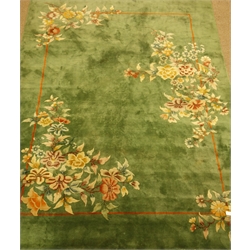  Oriental washed woollen green ground rug carpet decorated with flowers, outlined border in orange, 355cm x 270cm  