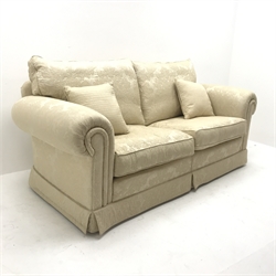 Duresta two seat sofa upholstered in Ivory coloured fabric with floral pattern, scrolled arms, W205cm