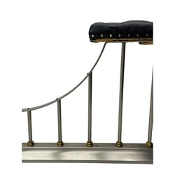 Brushed steel and brass club fire fender, upholstered corner seats in studded leather, the balustrade with lower lobed brass collars, on moulded skirt 