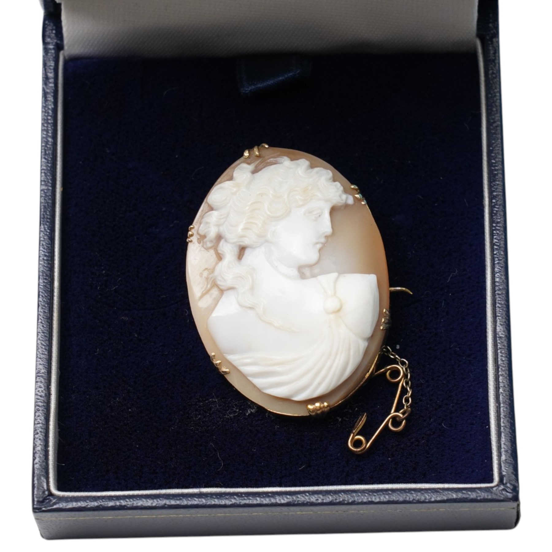Two silver hinged bangles, 9ct gold mounted shell carved cameo brooch, badges, beaded necklaces etc