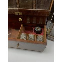 19th century mahogany travelling apothecary cabinet, with recessed brass carry handle to top, and two deep-section hinged doors to the front opening to reveal a fitted interior with clear glass bottles and two drawers, H27cm